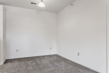 an empty room with carpet and white walls at Polo Run Apartments, Greenwood, IN